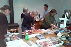 Cutting up the meat and mixing the herbs and spices.